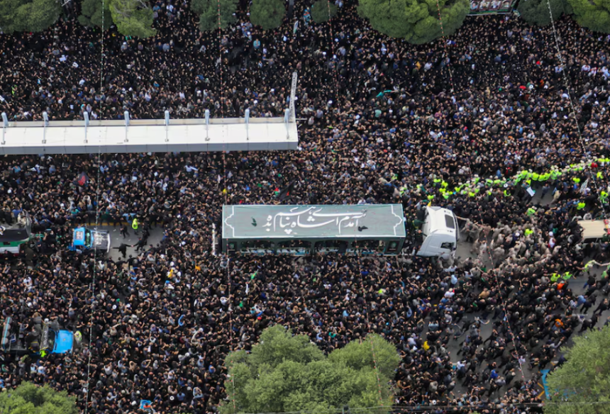 Mourners attend a burial ceremony of the late Iran's President Ebrahim Raisi in Mashhad