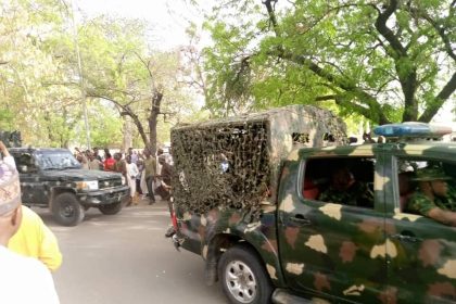 Soldiers following Ado Bayero's convoy