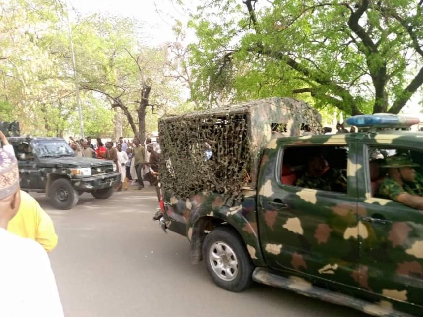 Soldiers following Ado Bayero's convoy