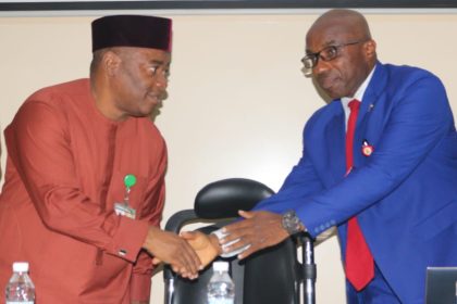 Dr Emeka Obi in a handshake with Olufunso Adebiyi