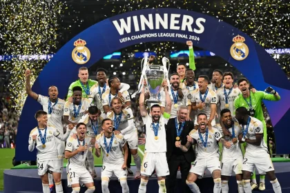 Real Madrid’s players lift the trophy to celebrate their victory at the end of the UEFA Champions League final