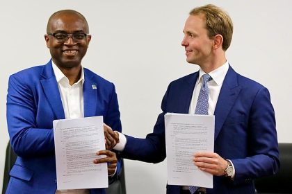 Olalekan Ogunleye and Karl Fredrik Staubo display documents shortly after signing the Project Development Agreement (PDA) between the NNPC Ltd and Golar LNG Ltd 