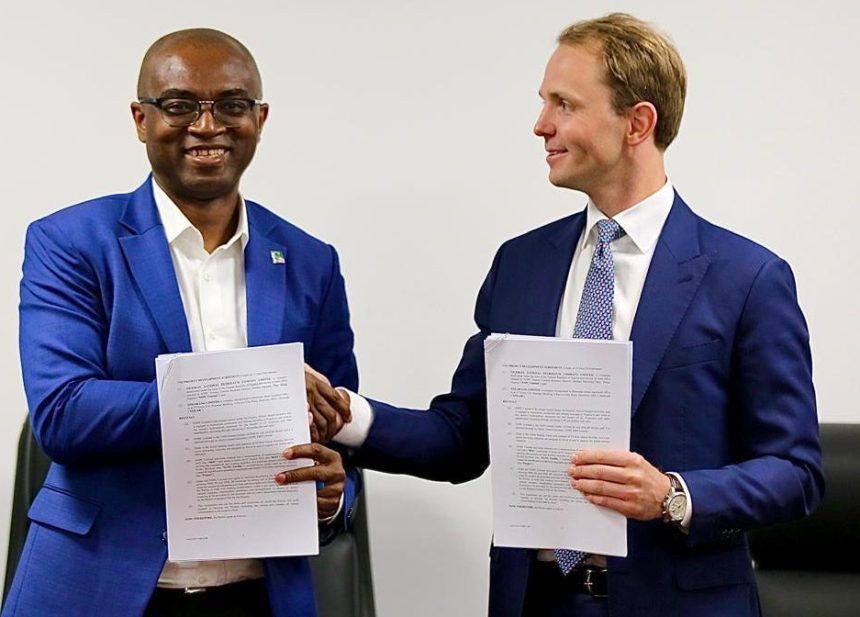 Olalekan Ogunleye and Karl Fredrik Staubo display documents shortly after signing the Project Development Agreement (PDA) between the NNPC Ltd and Golar LNG Ltd 