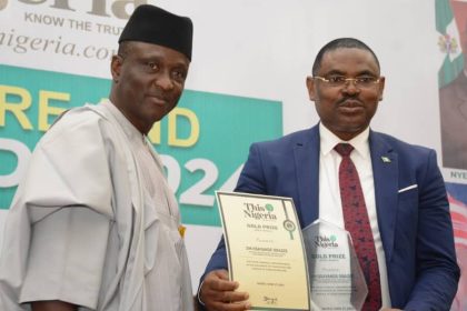 Gen. Adamu Jeeda presenting an award to Jim Obazee