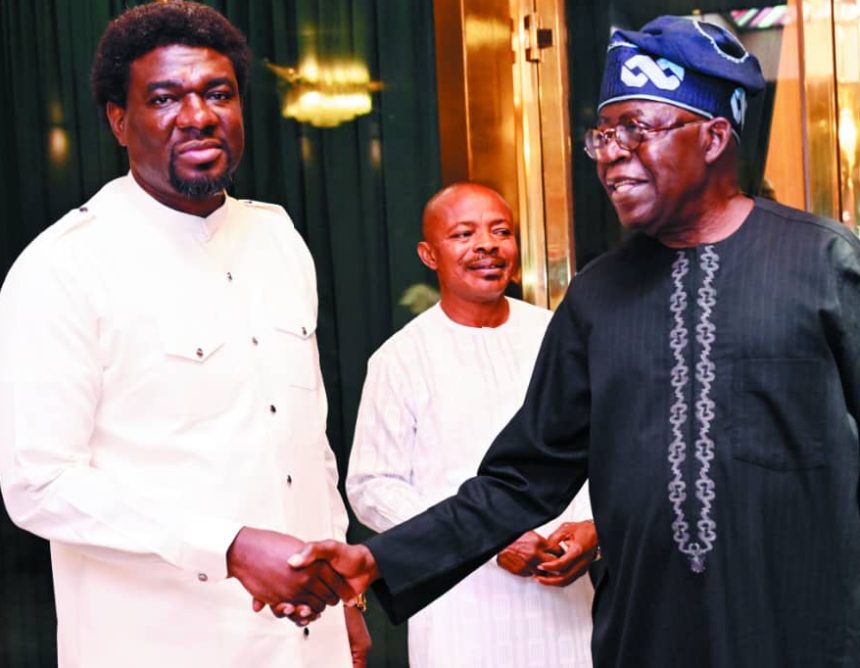 Tinubu shakes hand with Festus Osifo while Joe Ajaero looks on