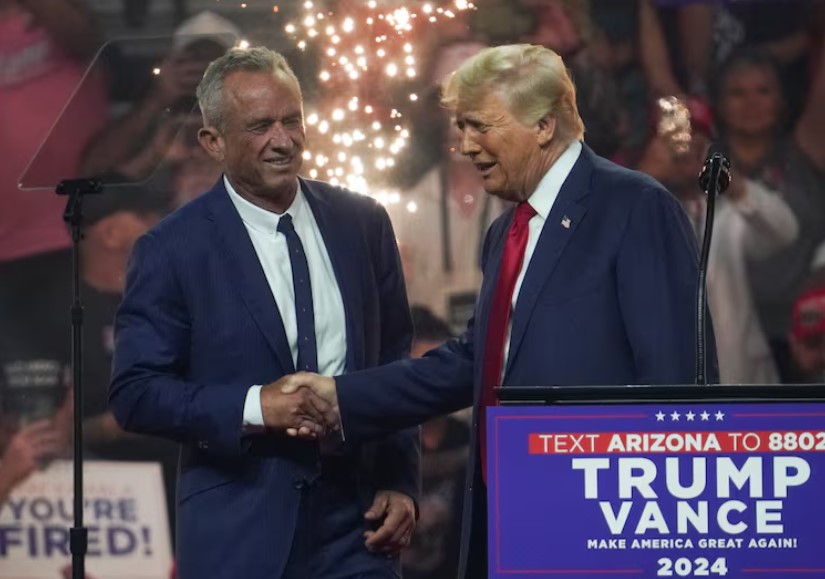 Robert F. Kennedy Jr. in a handshake with Donald Trump