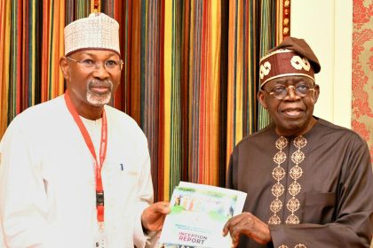 Attahiru Jega submitting the committee's report to President Tinubu