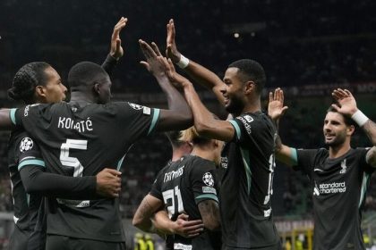 Liverpool's Virgil van Dijk celebrates with team mates after scoring his side's second goal during the Champions League opening phase soccer match between AC Milan and Liverpool at the San Siro stadium in Milan,