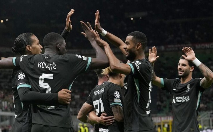 Liverpool's Virgil van Dijk celebrates with team mates after scoring his side's second goal during the Champions League opening phase soccer match between AC Milan and Liverpool at the San Siro stadium in Milan,