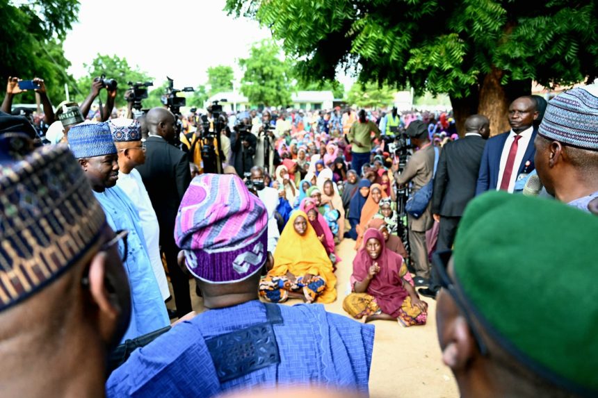 President Tinubu(backing camera) addressing flood victims