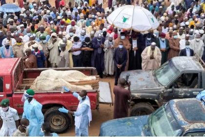 Trucks carry the wrapped bodies of people killed by suspected Boko Haram militant