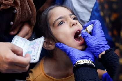 A Palestinian girl is vaccinated against polio, amid the Israel-Hamas conflict