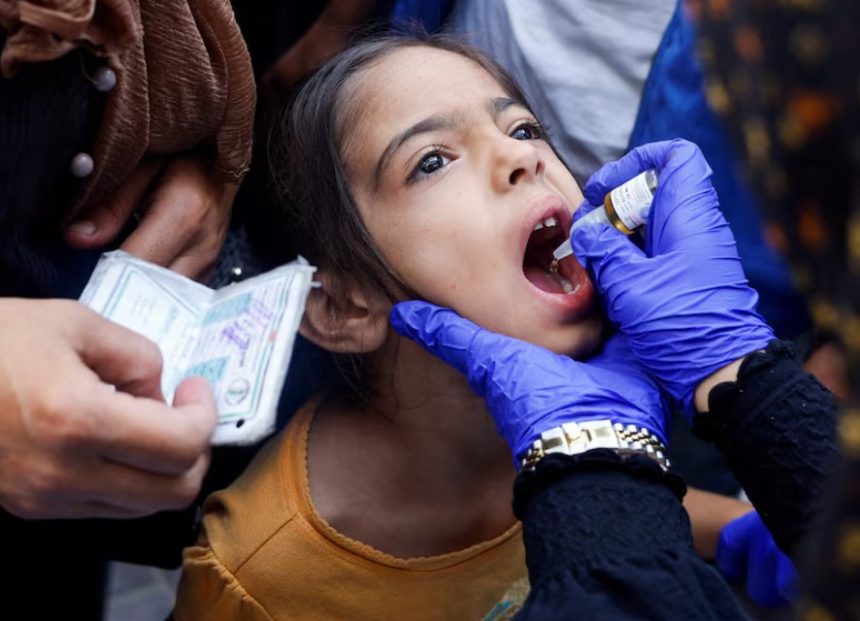 A Palestinian girl is vaccinated against polio, amid the Israel-Hamas conflict