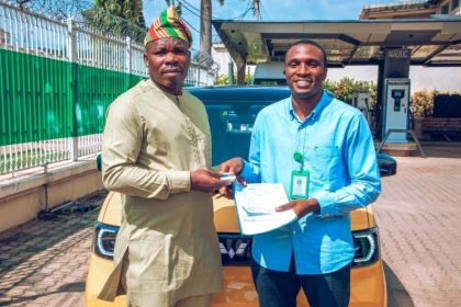 NACDC DG Joseph Osanipin presenting an electric car key in honour and copy of Memorandum of Understanding signed with Enoch Tobiloba, an HND ll student of Yabatech