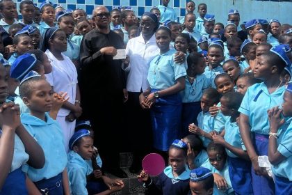 Obi presenting the cheque to Holy Rosary Sisters’ students