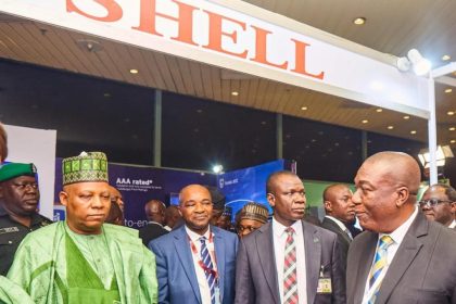 Kashim Shettima; Chairman, NESG Olaniyi Yusuf, a security detail and Shell’s Business Value Manager, Chidi Nkazi, at the exhibition booth of Shell