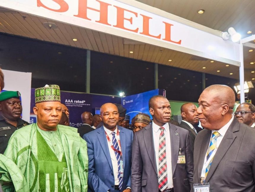 Kashim Shettima; Chairman, NESG Olaniyi Yusuf, a security detail and Shell’s Business Value Manager, Chidi Nkazi, at the exhibition booth of Shell