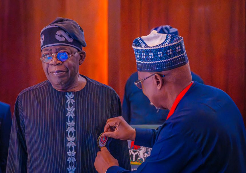 Tinubu being decorated with Legion emblem